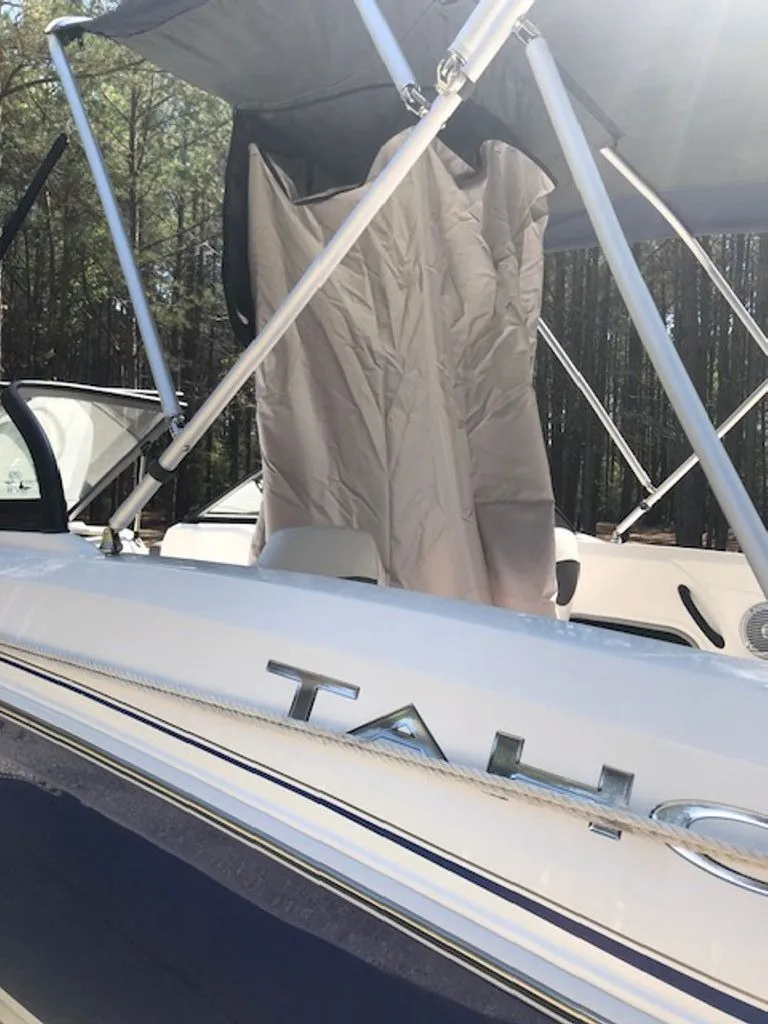 Slide: The Image of 2024 Tahoe 185 S boat with Bimini top in forest setting. - 31