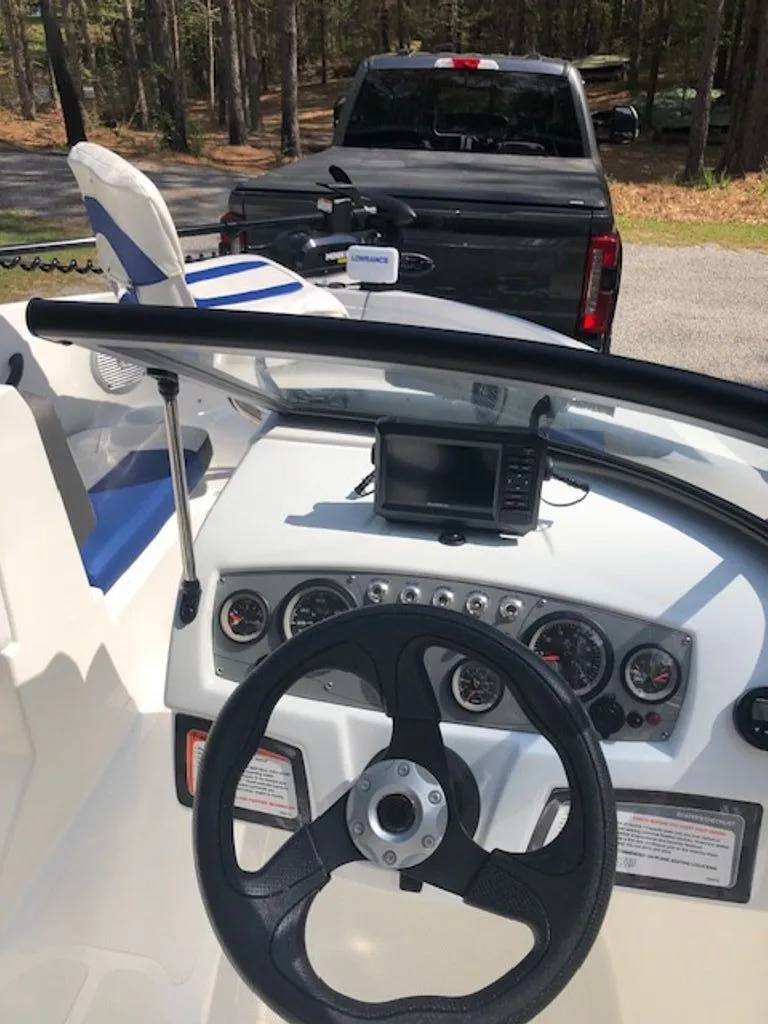 Slide: The Image of 2024 Tahoe 185 S boat with modern dashboard and steering wheel. - 5