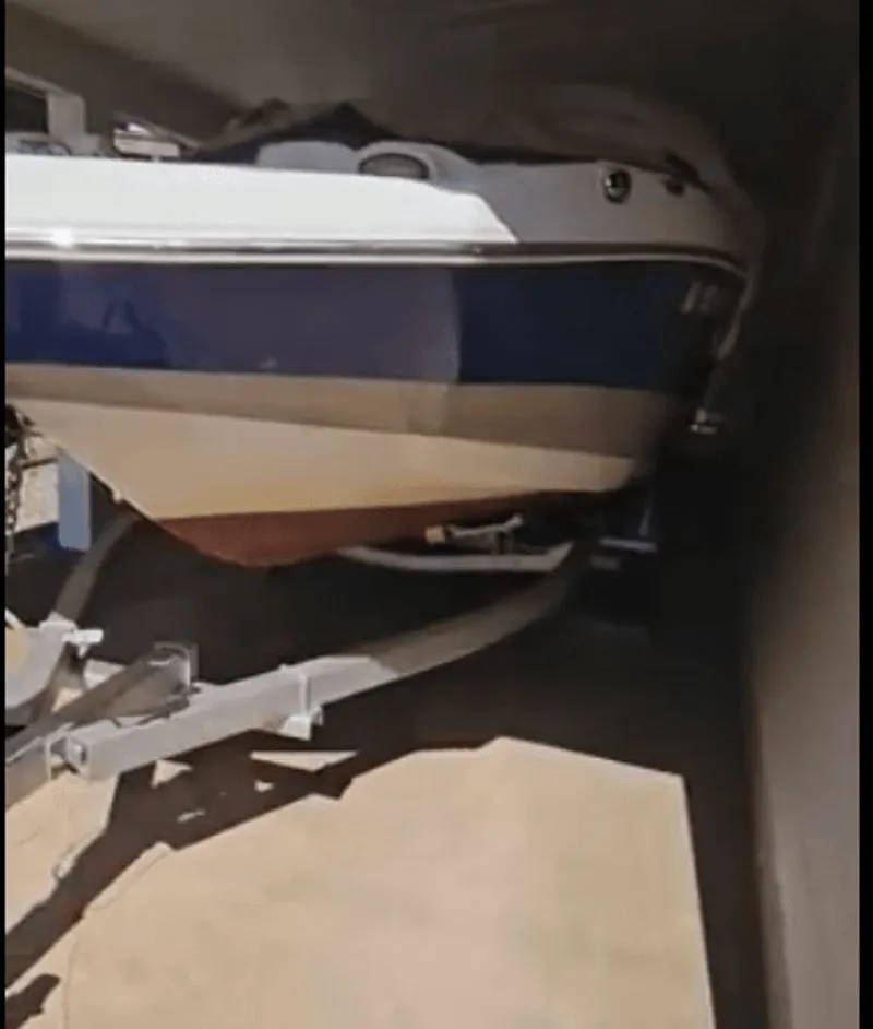 The Image of 2016 NauticStar 203 DC DB boat on trailer in garage. - 0