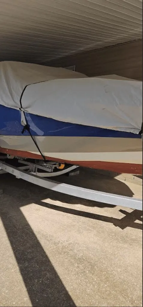 Slide: The Image of 2016 NauticStar 203 DC DB boat covered on trailer. - 3