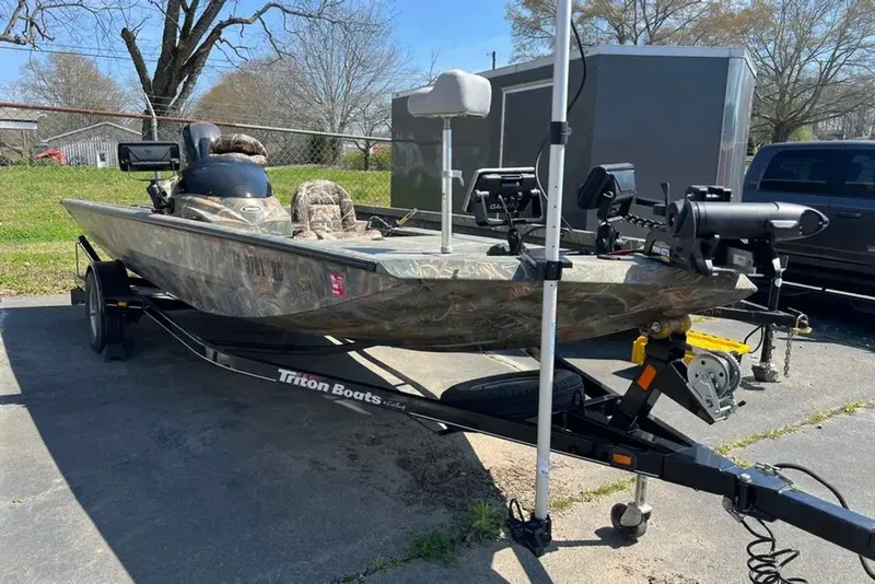 The Image of 2015 Hurricane Sundeck boat parked on trailer outdoors. - 0