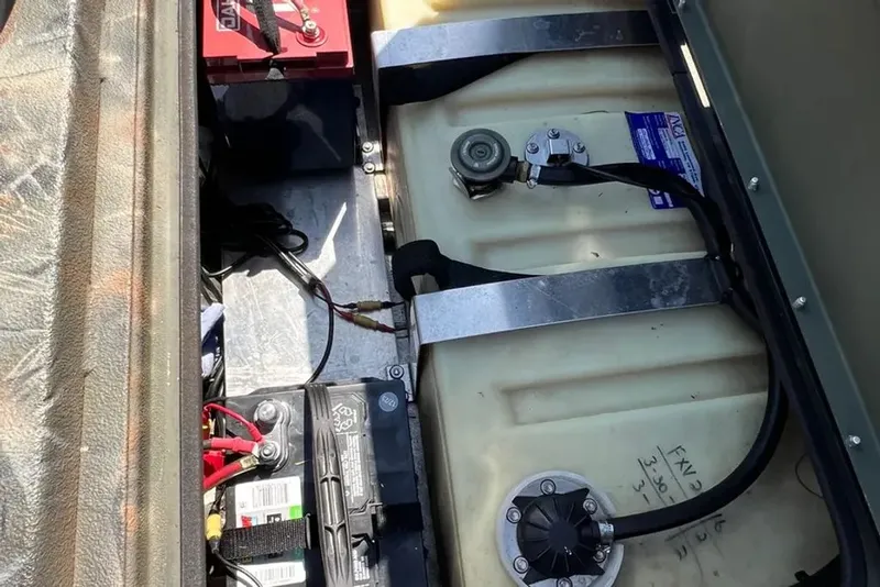 Slide: The Image of Battery compartment of a 2015 Hurricane Sundeck boat with cables and tanks. - 10