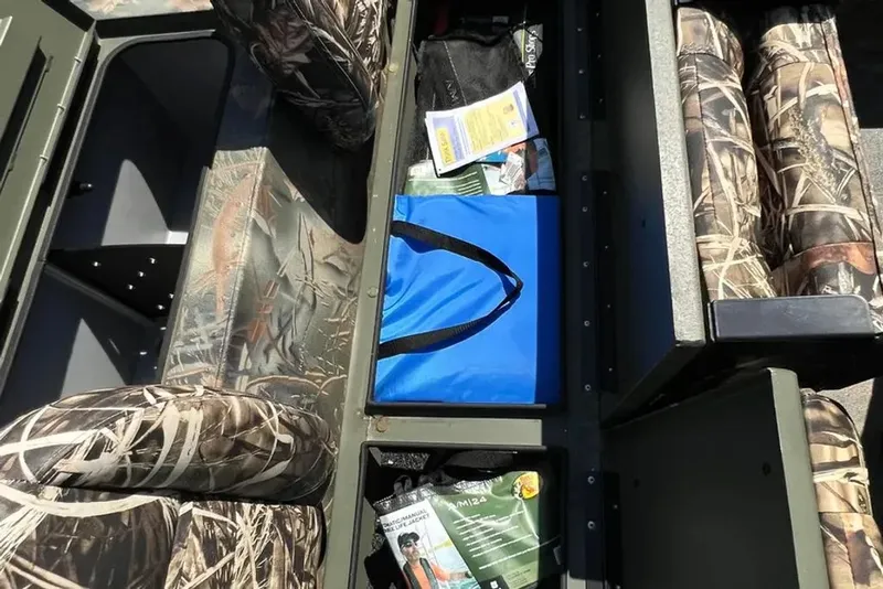 Slide: The Image of Interior of 2015 Hurricane Sundeck with camo-pattern seats and storage. - 12