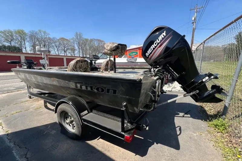 Slide: The Image of Triton boat with Mercury engine on trailer, sunny day. - 14