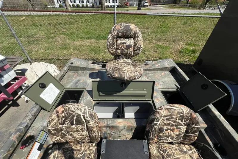Slide: The Image of 2015 Hurricane Sundeck boat with camouflage pattern and storage compartments. - 5