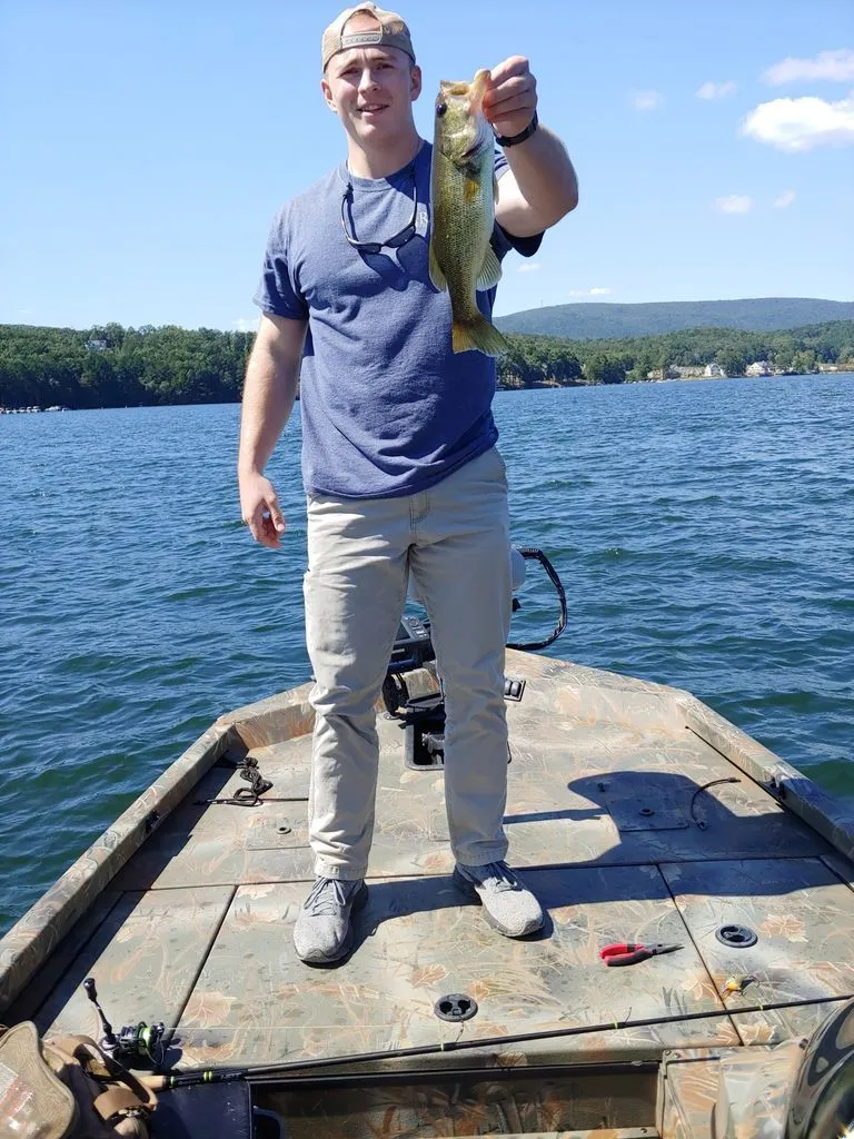 Slide: The Image of Angler on Triton 17 C TX boat holding a caught fish. - 23