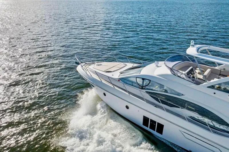Slide: The Image of Luxury 2016 Azimut 54 yacht cruising on open water, showcasing sleek design. - 10