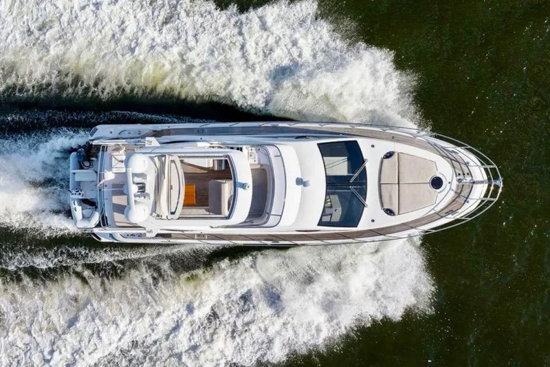 Slide: The Image of Aerial view of 2016 Azimut 54 yacht cruising on water, creating white wake. - 11