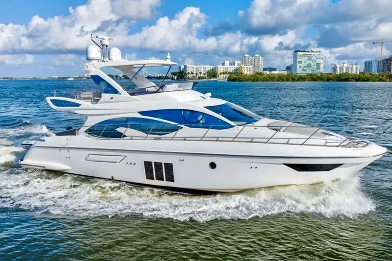 Slide: The Image of Luxury 2016 Azimut 54 yacht cruising on a sunny day near city skyline. - 12