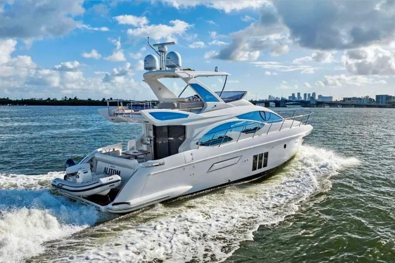 Slide: The Image of Luxurious 2016 Azimut 54 yacht cruising on open water under a partly cloudy sky. - 13