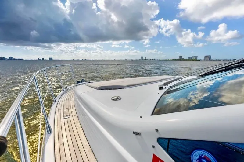Slide: The Image of 2016 Azimut 54 yacht cruising on open water under a partly cloudy sky. - 16