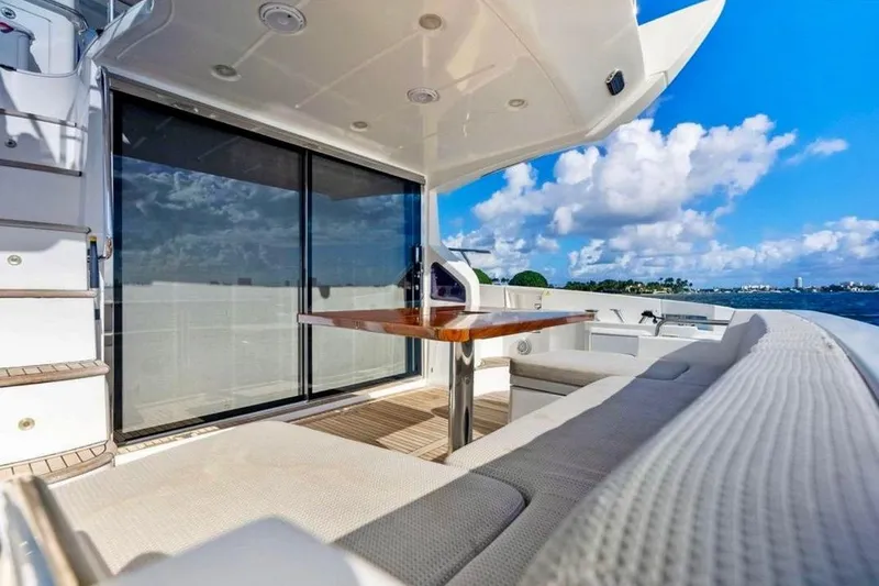 Slide: The Image of Luxurious 2016 Azimut 54 yacht deck with seating, table, and ocean view. - 18