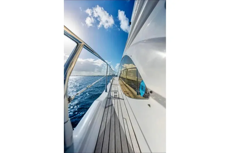 Slide: The Image of Side view of 2016 Azimut 54 yacht on open sea under clear blue sky. - 26