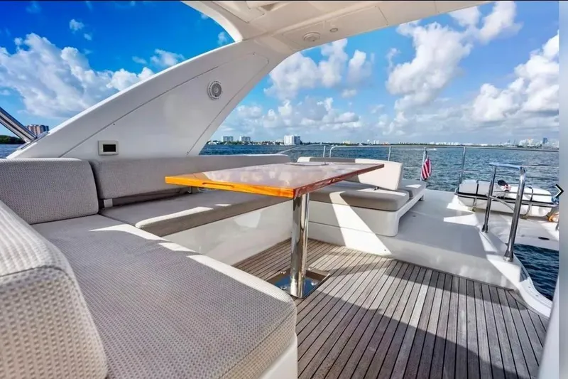 Slide: The Image of Luxurious 2016 Azimut 54 yacht deck with seating, table, and ocean view. - 27