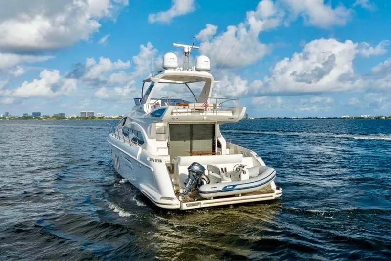 Slide: The Image of Luxury 2016 Azimut 54 yacht cruising on open water under a blue sky. - 3