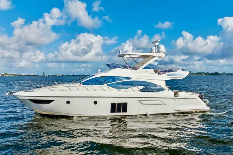 Slide: The Image of Luxurious 2016 Azimut 54 yacht cruising on open water under a clear blue sky. - 5