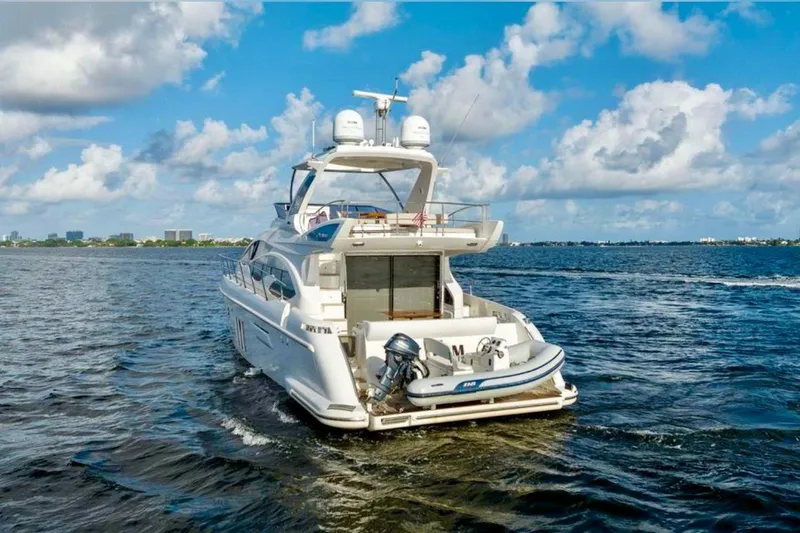 Slide: The Image of Luxury 2016 Azimut 54 yacht cruising on open water under a blue sky. - 6