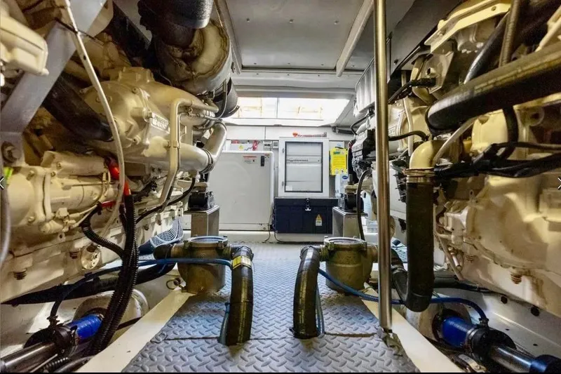 Slide: The Image of Engine room of a 2016 Azimut 54 yacht, showcasing dual engines and mechanical components. - 60