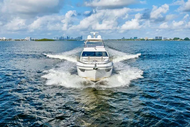 Slide: The Image of 2016 Azimut 54 yacht cruising on open water under a partly cloudy sky. - 8