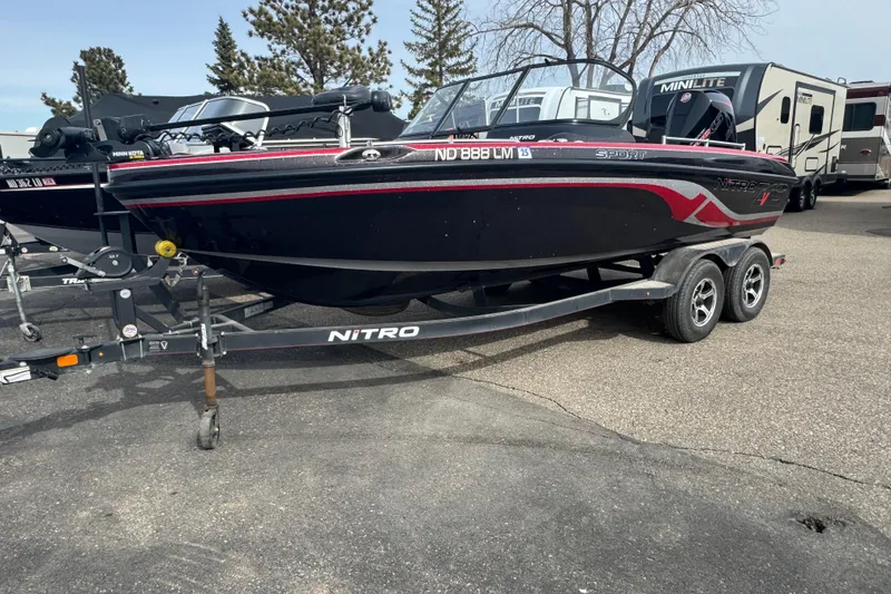 The Image of 2020 Nitro ZV19 Sport boat on trailer, parked outdoors near RVs. - 1
