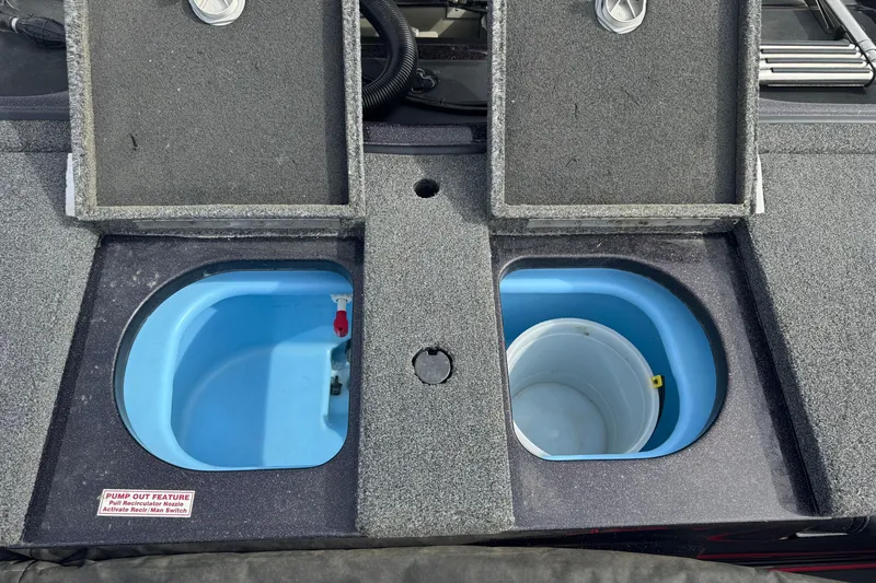 Slide: The Image of 2020 Nitro ZV19 Sport boat livewell compartments with pump-out feature and storage bucket. - 15