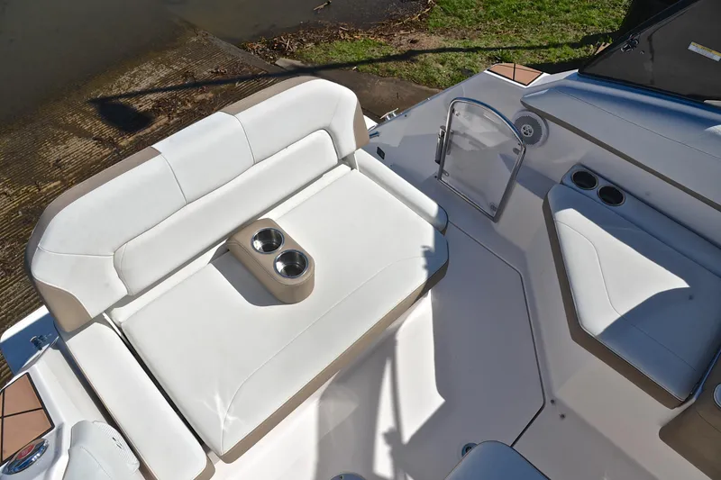 Slide: The Image of 2016 Regal 26 Express boat interior with white seating and cup holders. - 23