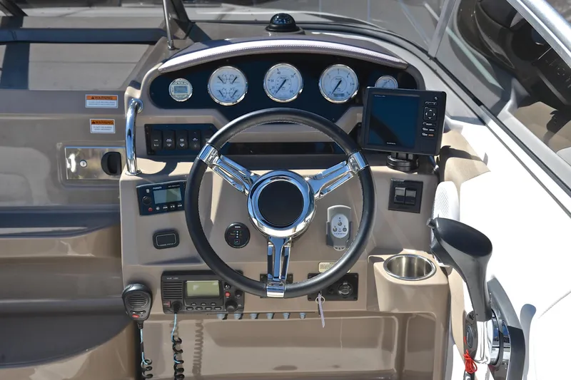 Slide: The Image of Cockpit of 2016 Regal 26 Express boat with steering wheel and navigation instruments. - 25
