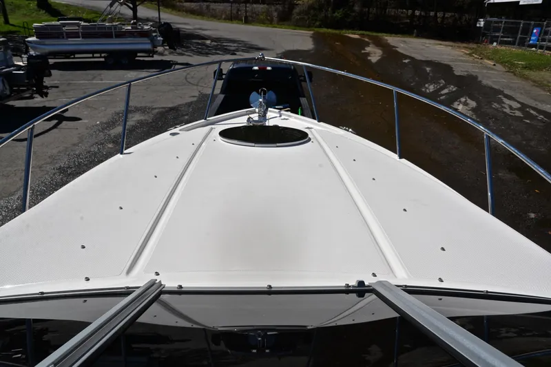 Slide: The Image of 2016 Regal 26 Express boat deck view in a parking area. - 27