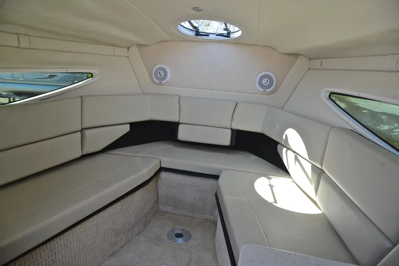 Slide: The Image of Interior cabin of 2016 Regal 26 Express boat with beige seating and windows. - 29