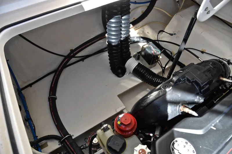 Slide: The Image of Engine compartment of a 2016 Regal 26 Express boat, showcasing mechanical components and wiring. - 35