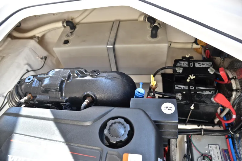 Slide: The Image of Engine compartment of a 2016 Regal 26 Express boat, featuring batteries and components. - 36