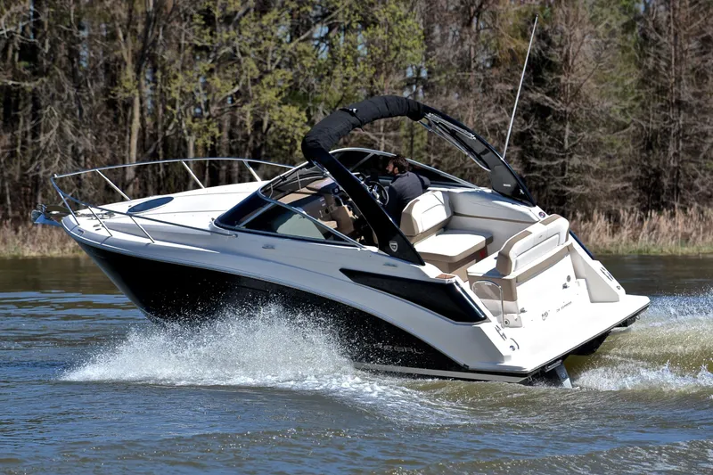 Slide: The Image of 2016 Regal 26 Express boat cruising on a lake with trees in the background. - 7