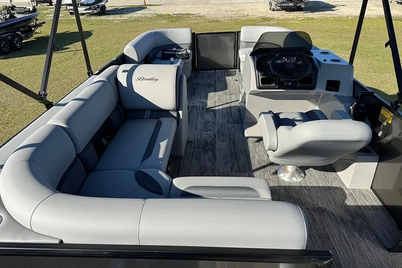 Slide: The Image of 2026 Bentley Pontoons 243 Fish-N-Cruise interior with plush seating and modern helm. - 12