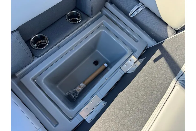 Slide: The Image of 2026 Bentley Pontoons 243 Fish-N-Cruise storage compartment with cup holders and wrapped item. - 27