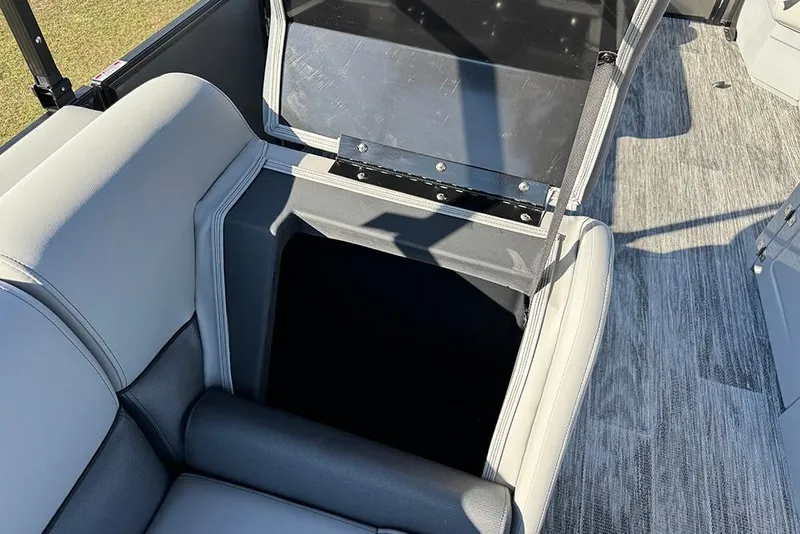 Slide: The Image of 2026 Bentley Pontoons 243 Fish-N-Cruise storage compartment with open lid and seating. - 28