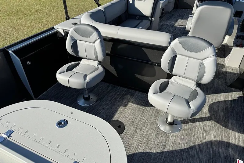 Slide: The Image of 2026 Bentley Pontoons 243 Fish-N-Cruise interior with swivel seats and fishing table. - 40