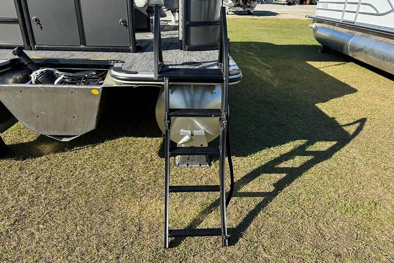 Slide: The Image of Rear view of 2026 Bentley Pontoons 243 Fish-N-Cruise with ladder on grass. - 5
