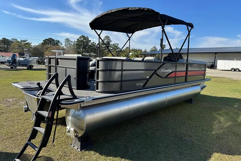 Slide: The Image of 2026 Bentley Pontoons 243 Fish-N-Cruise pontoon boat on grass, featuring a canopy and ladder. - 6