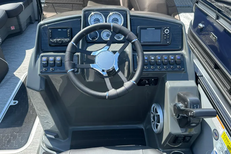 Slide: The Image of Steering console of 2026 Sylvan X3 CLZ DH boat with modern controls and gauges. - 13
