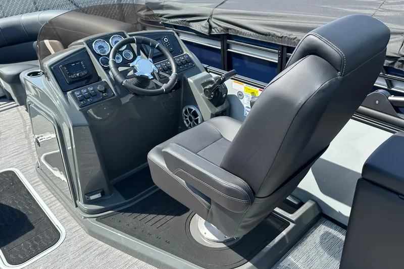 Slide: The Image of 2026 Sylvan X3 CLZ DH boat cockpit with steering wheel and captain's chair. - 14