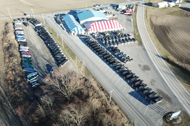 Slide: The Image of Aerial view of Sylvan X3 CLZ DH boats displayed at a dealership, 2026 model. - 6