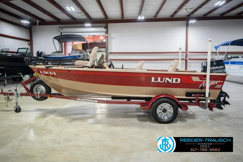 Slide: The Image of 1997 Lund 1650 Angler SS boat on trailer in indoor showroom. - 10