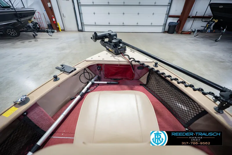 Slide: The Image of 1997 Lund 1650 Angler SS boat interior with trolling motor in a garage setting. - 17