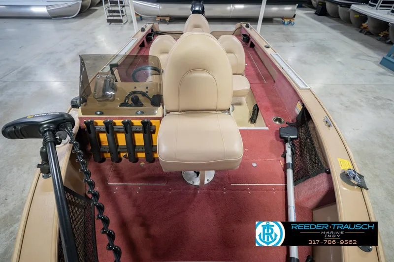 Slide: The Image of 1997 Lund 1650 Angler SS boat interior with beige seats and red carpet. - 18