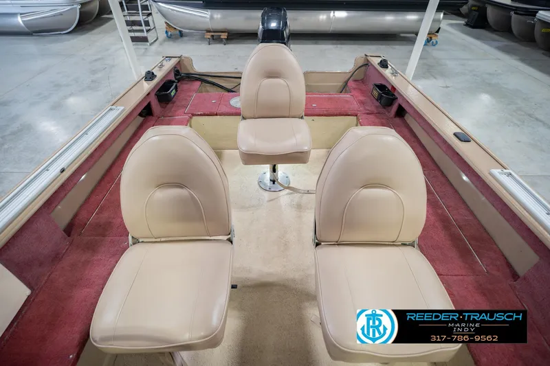 Slide: The Image of 1997 Lund 1650 Angler SS boat interior with beige seats and red carpet. - 19