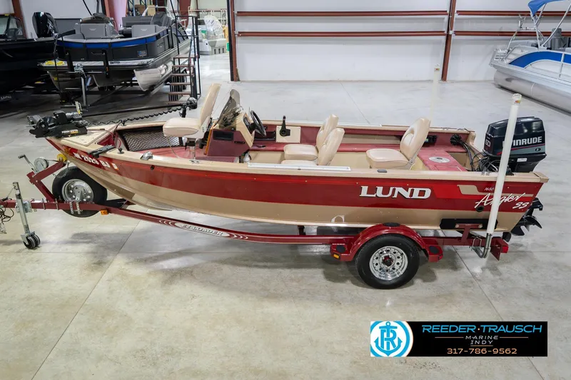The Image of 1997 Lund 1650 Angler SS fishing boat on trailer in indoor showroom. - 2