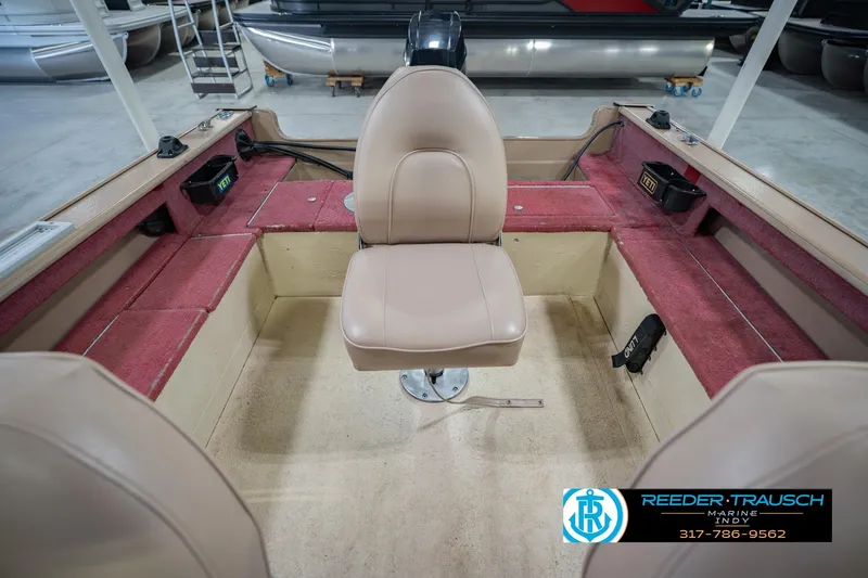 Slide: The Image of 1997 Lund 1650 Angler SS boat interior with beige seat and red carpeted sides. - 20