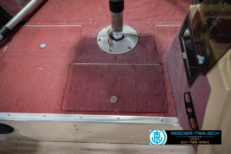 Slide: The Image of Red carpeted deck of a 1997 Lund 1650 Angler SS boat interior. - 25
