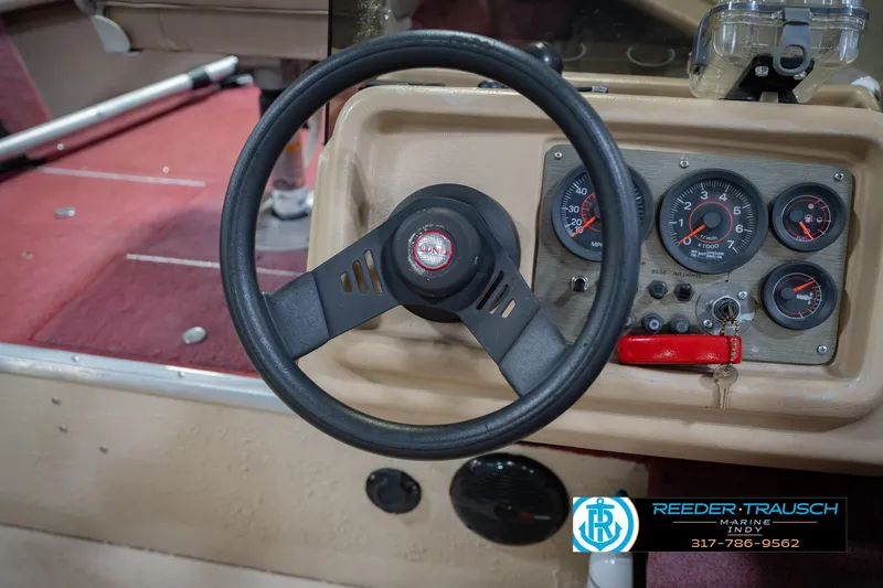 Slide: The Image of Steering wheel and dashboard of a 1997 Lund 1650 Angler SS boat. - 27