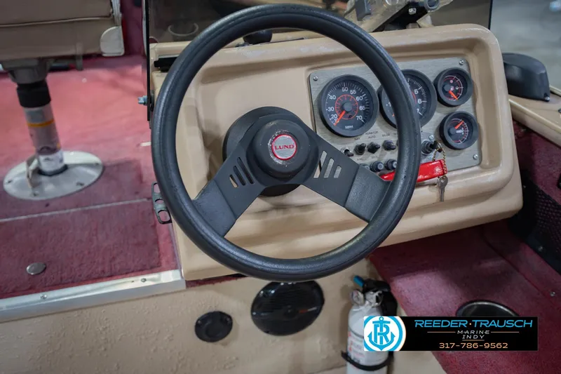 Slide: The Image of Steering wheel and dashboard of a 1997 Lund 1650 Angler SS boat. - 28